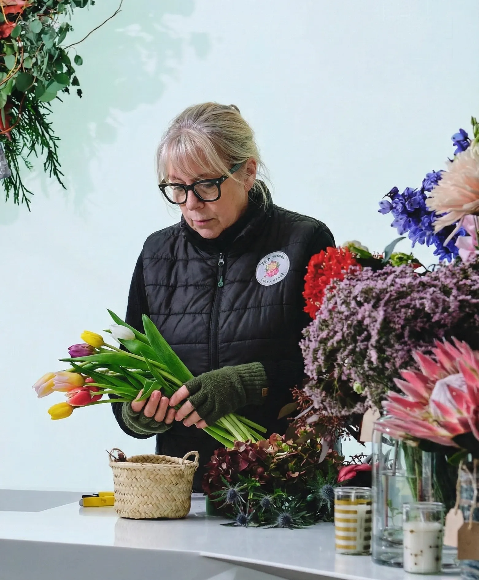Phyllis inspecting a flower in her studio